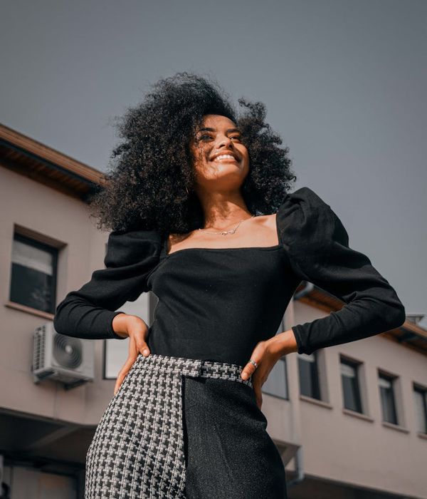 Woman feeling energetic and vibrant in a bright, modern space.